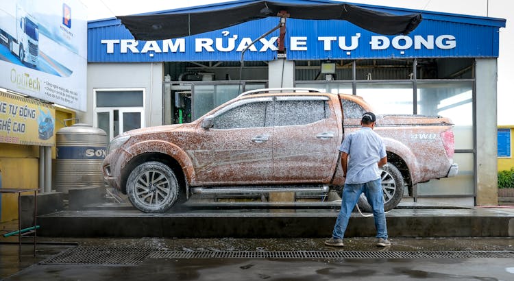 Man In White Shirt Cleaning Brown Pickup Truck