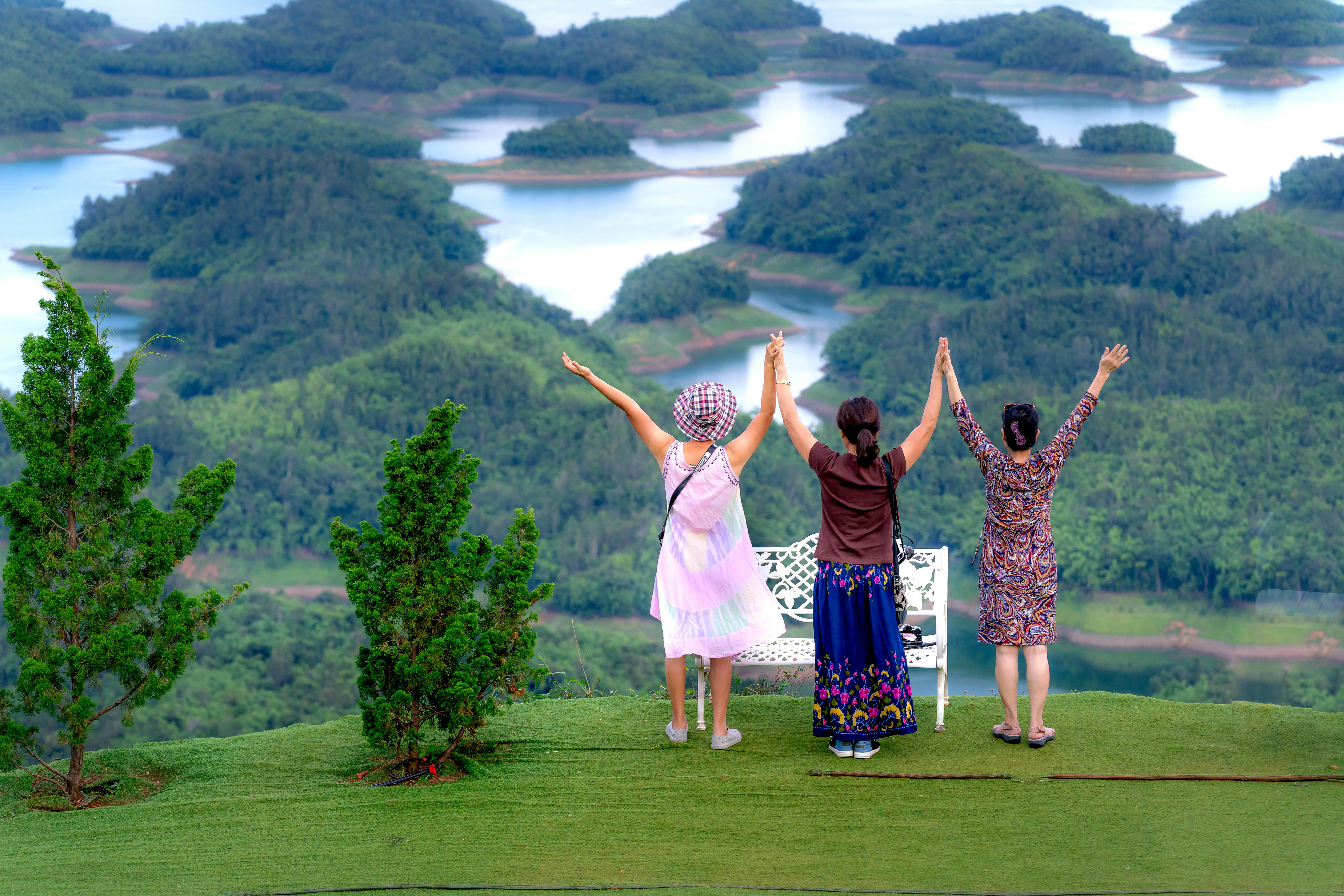 Backview of Women holding each other's Hands overlooking the View
