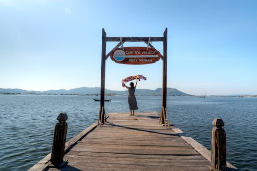 Woman Standing on a Wooden Dock