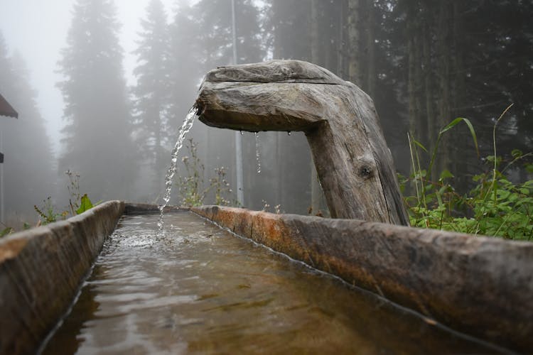 Water Falling Into A Wooden Gutter