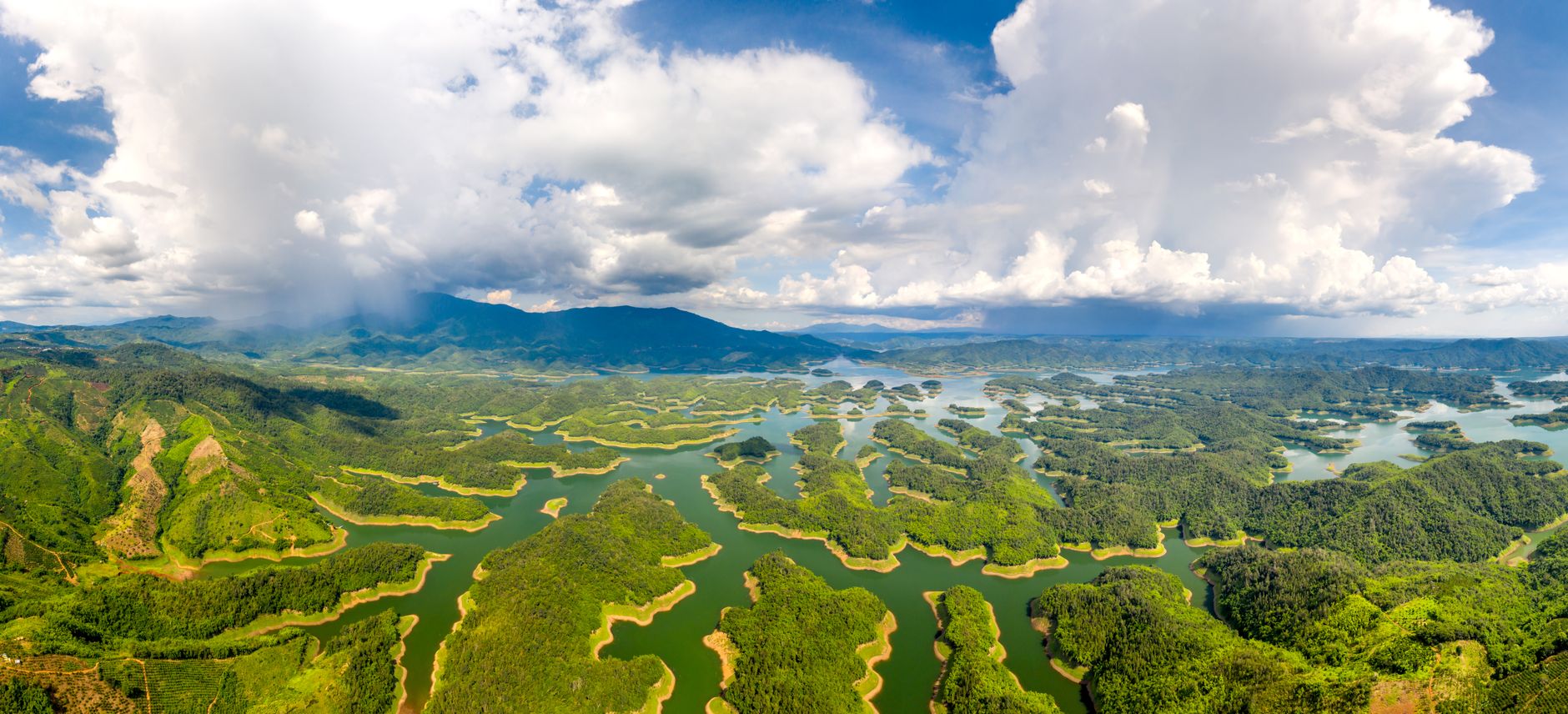A breathtaking aerial view of Ta Dung National Park, showcasing lush forests and vibrant waterways.