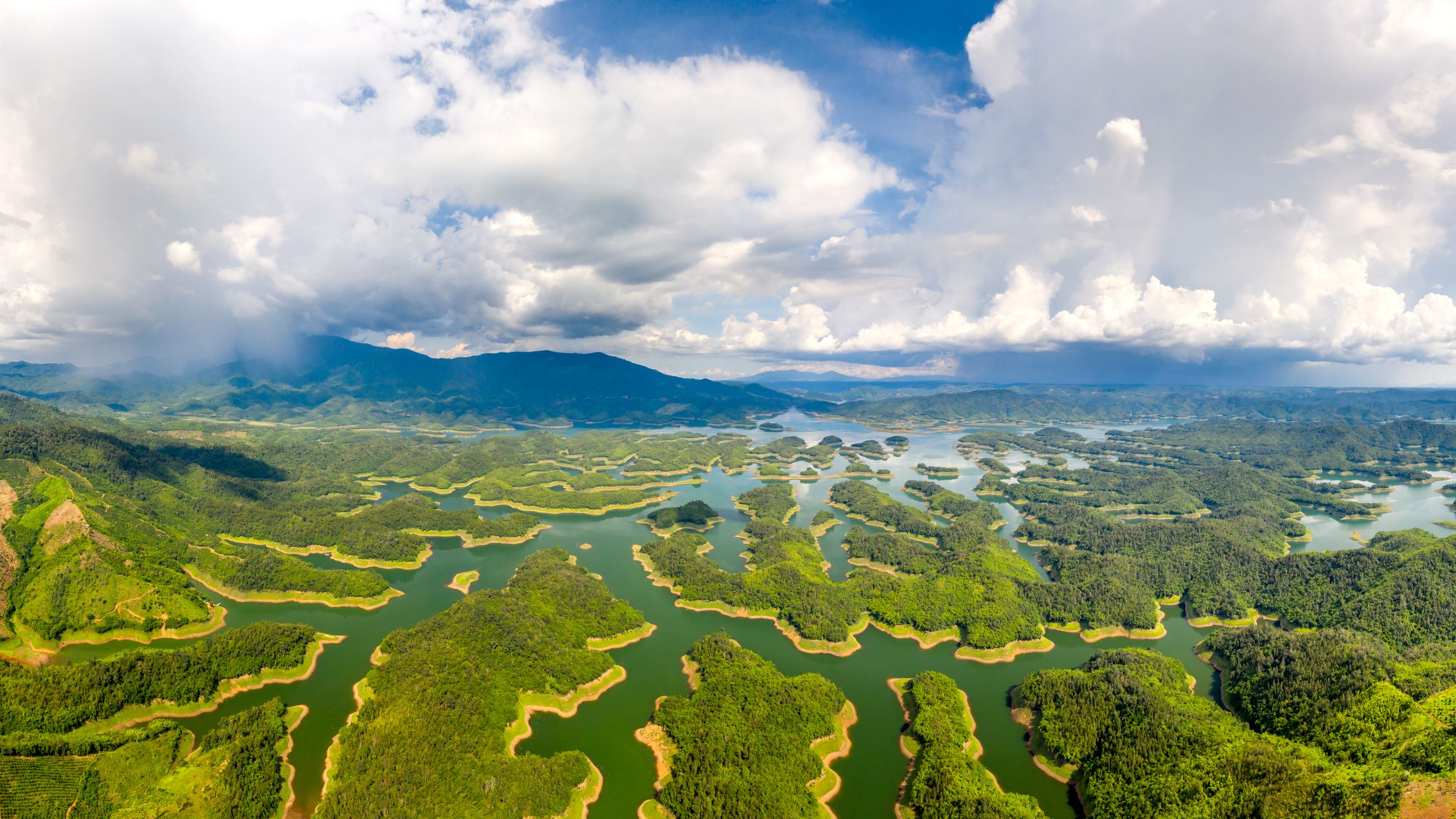A breathtaking aerial view of Ta Dung National Park, showcasing lush forests and vibrant waterways.