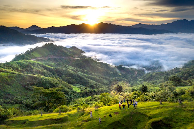 People Standing In A Circle In The Mountains