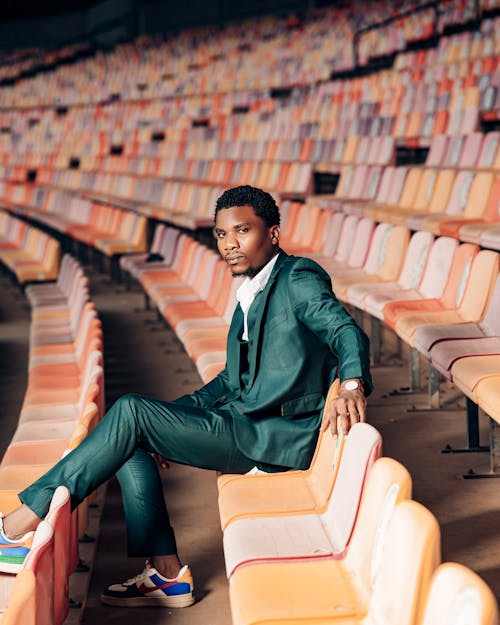 Man in a Suit Sitting in the Stadium Seat 