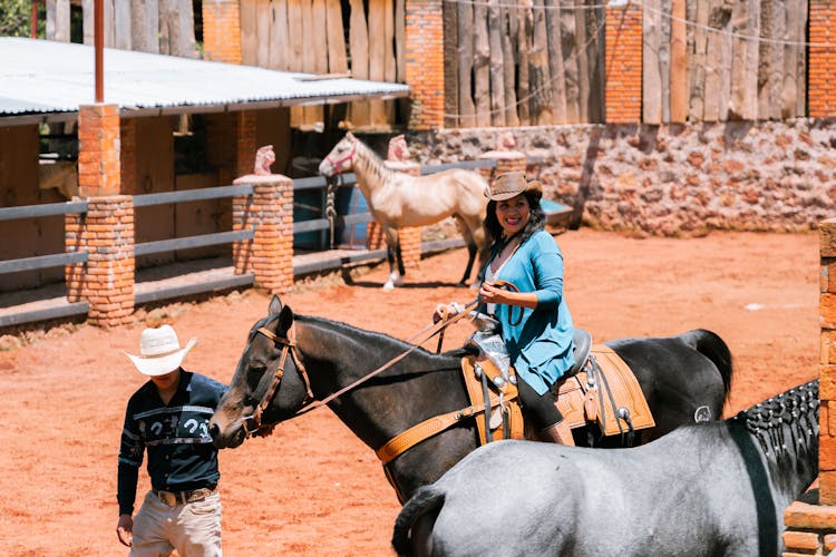 Woman Learning Horseback Riding In Paddock