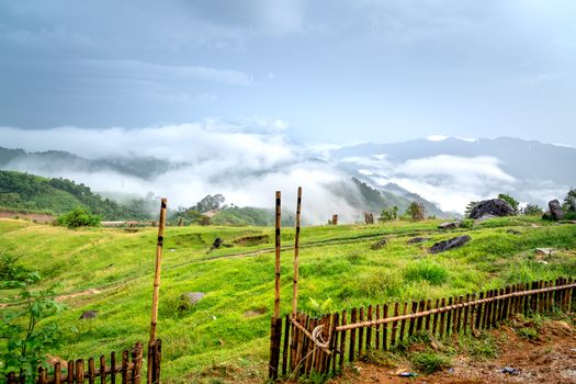 Peaceful mountain scene with rolling hills and fog, offering a serene escape in summer.