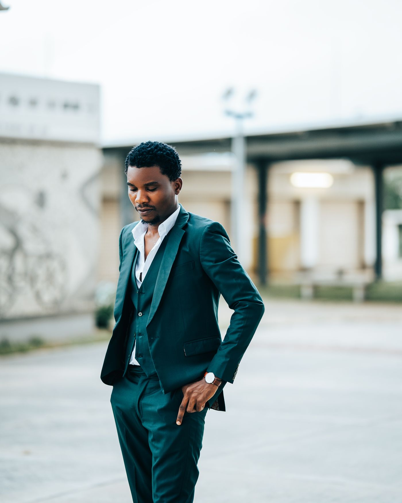 A man in a three-piece suit in a courtyard in Abuja.