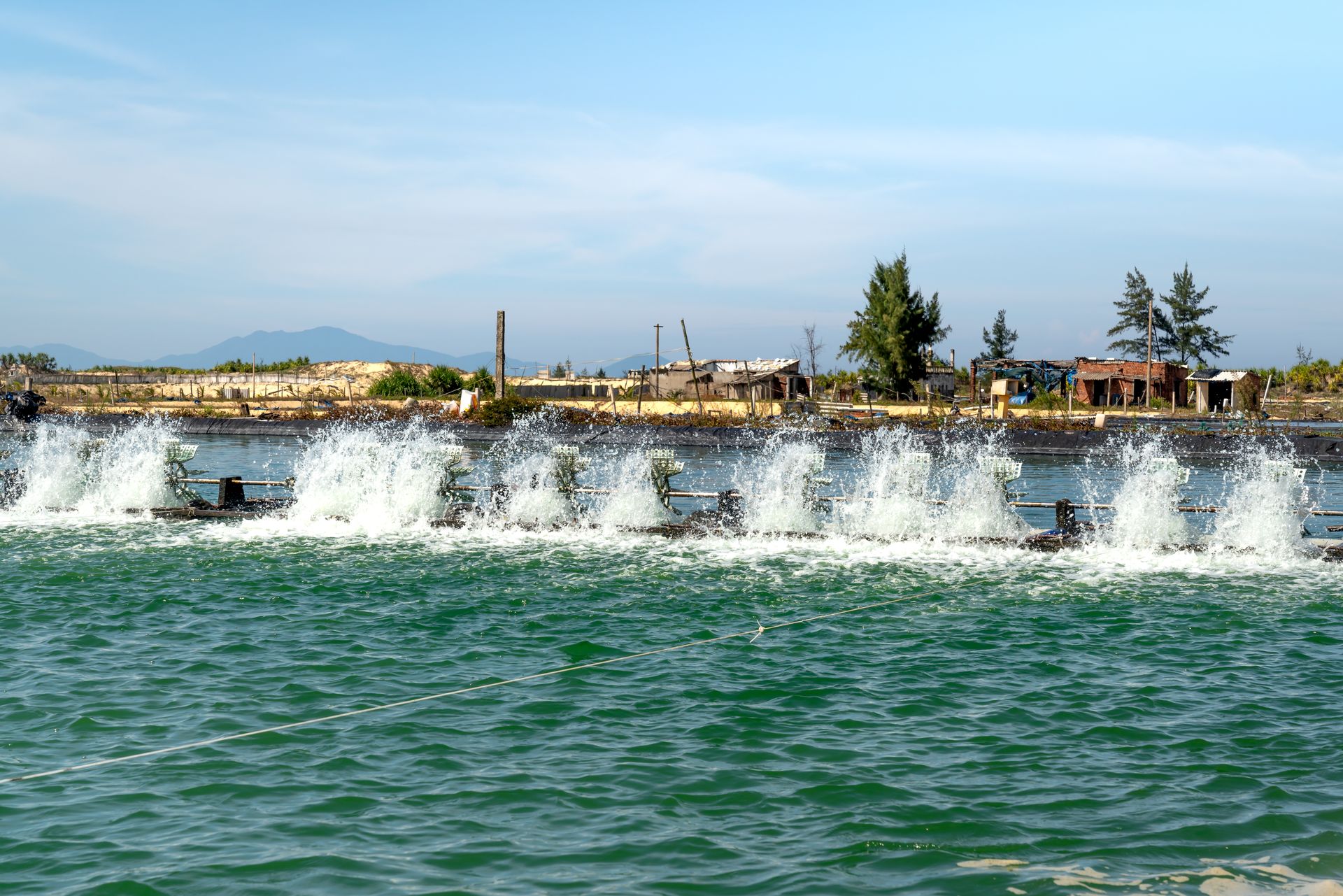 A high-powered water aerator in action at an aquaculture facility, creating a vibrant splash.