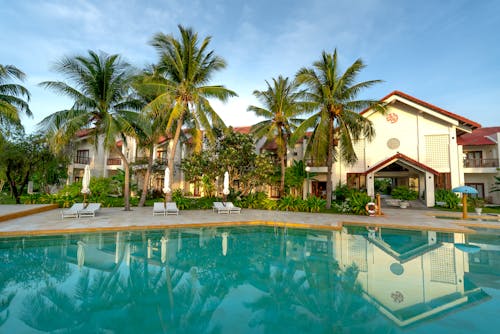 White and Brown Concrete Villas Near Swimming Pool