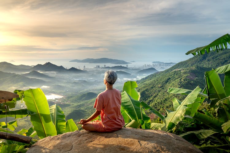 Woman Looking At Beautiful Landscape And Doing Yoga