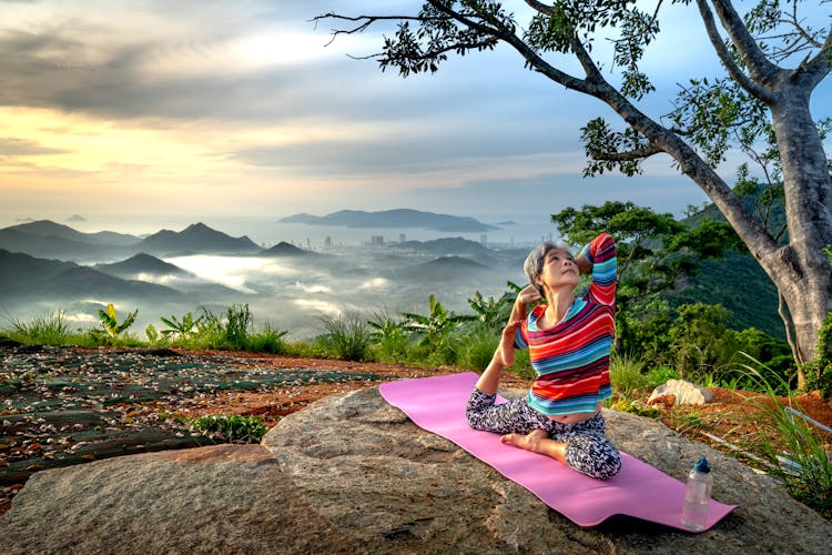 Senior Woman Stretching Her Legs On Yoga  Mat 