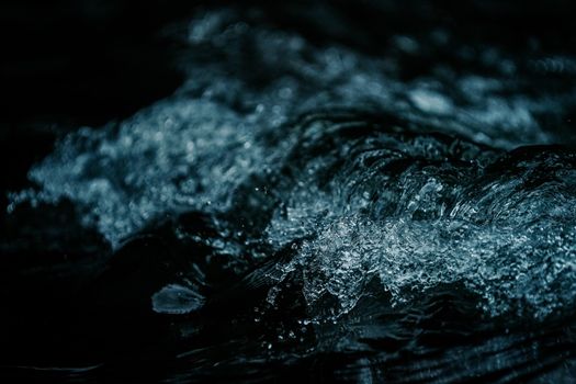 Captivating dark water macro photography showcasing dynamic ripples and texture.