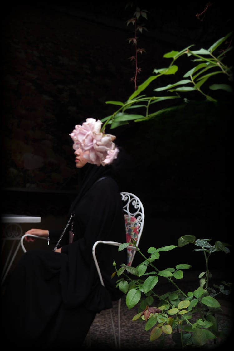 Woman In Abaya With Flower Instead Head In Garden
