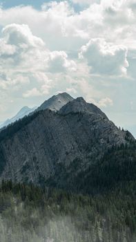 Scenic mountain view in Banff National Park, showcasing rugged peaks and lush forests.