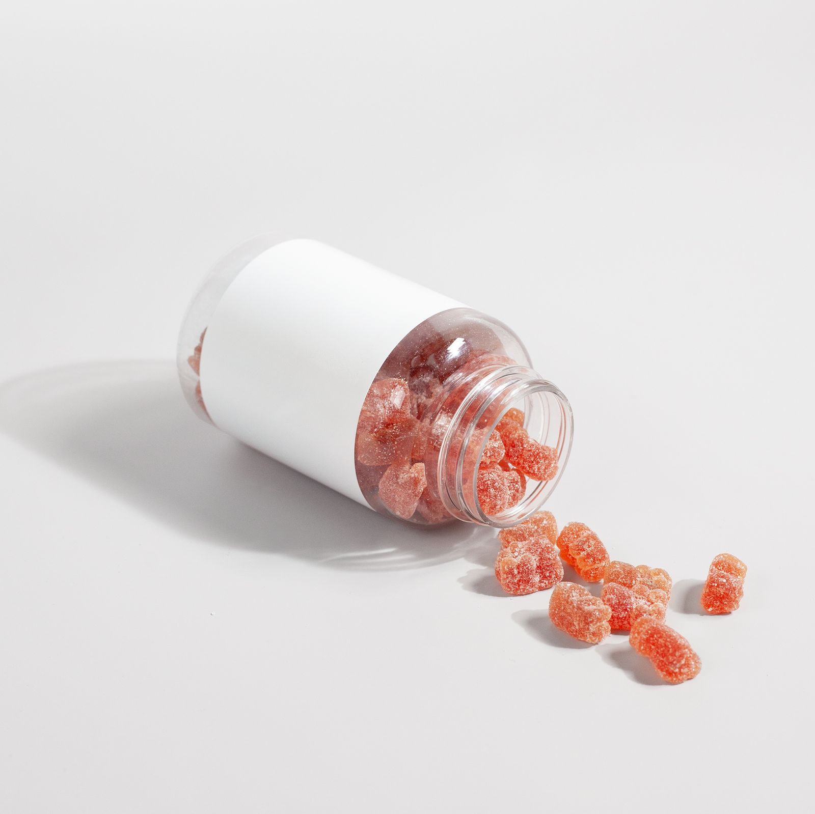 A close-up of supplement gummies on a plain white surface, the chewable format that delivers a measured daily fiber dose