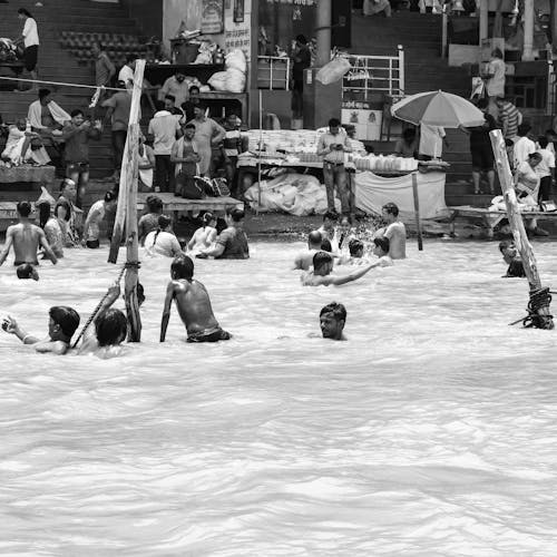 Grayscale Photography of People Enjoying the Pool