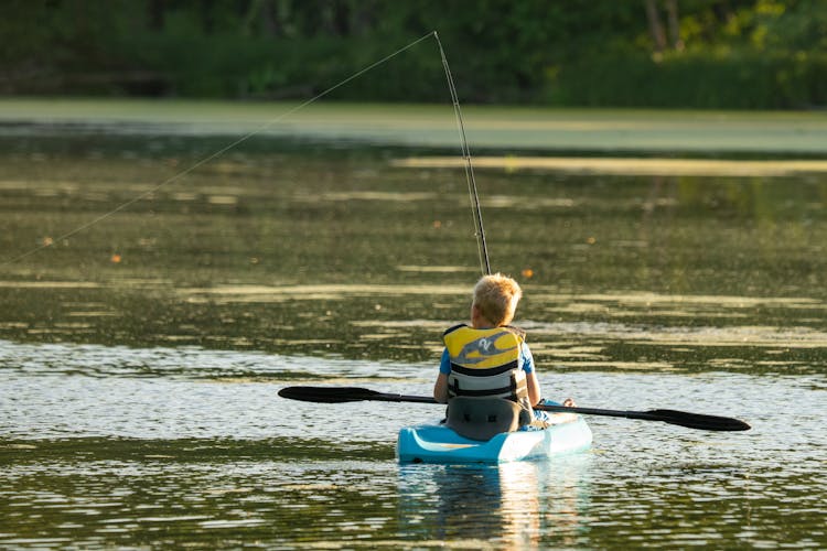 Boy Fishing From The Kayak