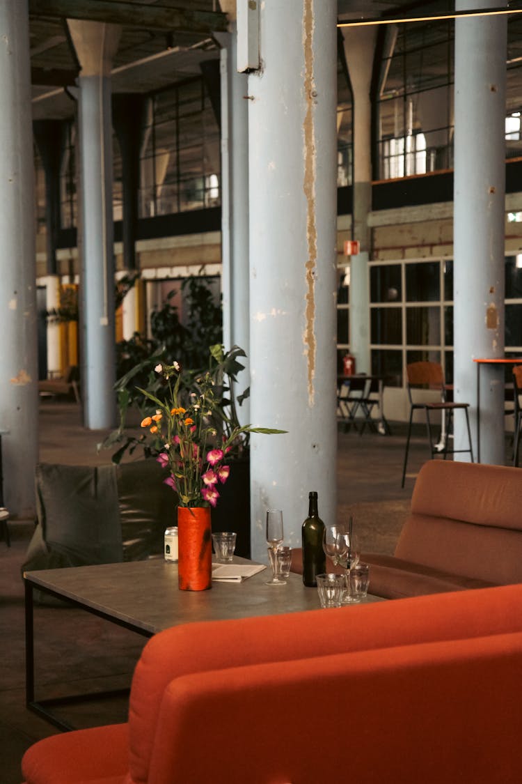 Flowers And Glasses On Table In Lobby