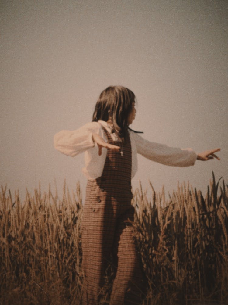 Girl Standing In A Field