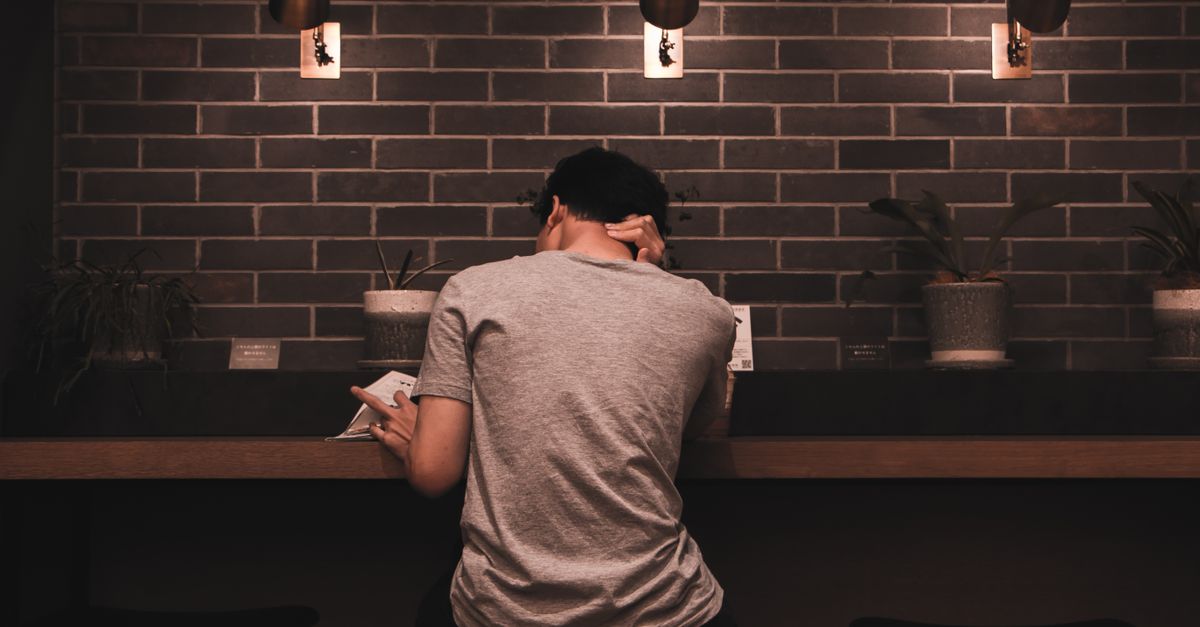 person reading documents alone in quiet cafe