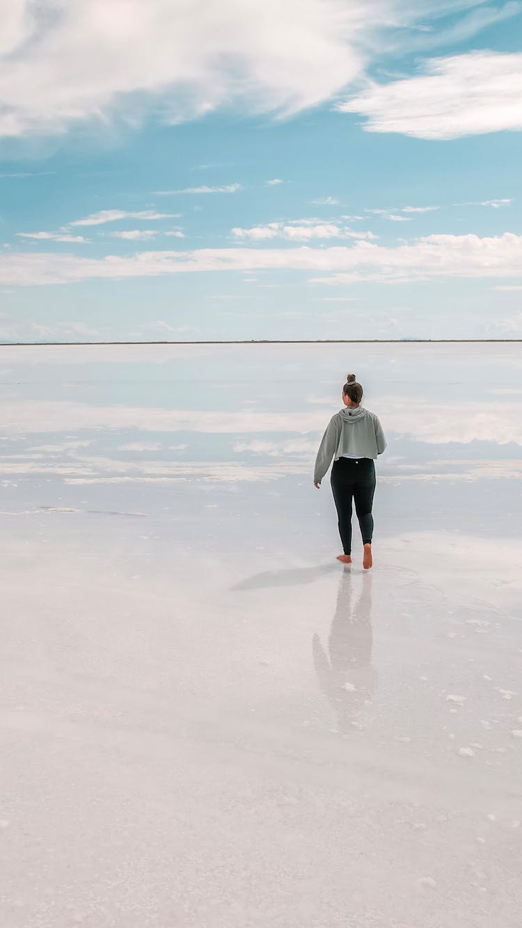 Woman Walking Down A Beach