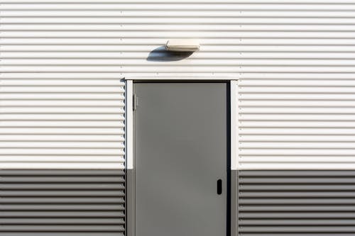 Free Door in a Wall Covered in Siding Stock Photo