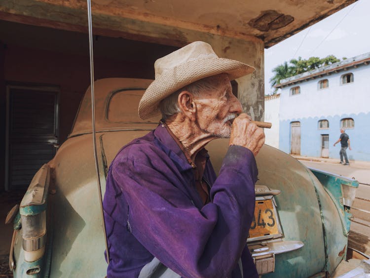 Man In Purple Long Sleeves Shirt Smoking A Tobacco