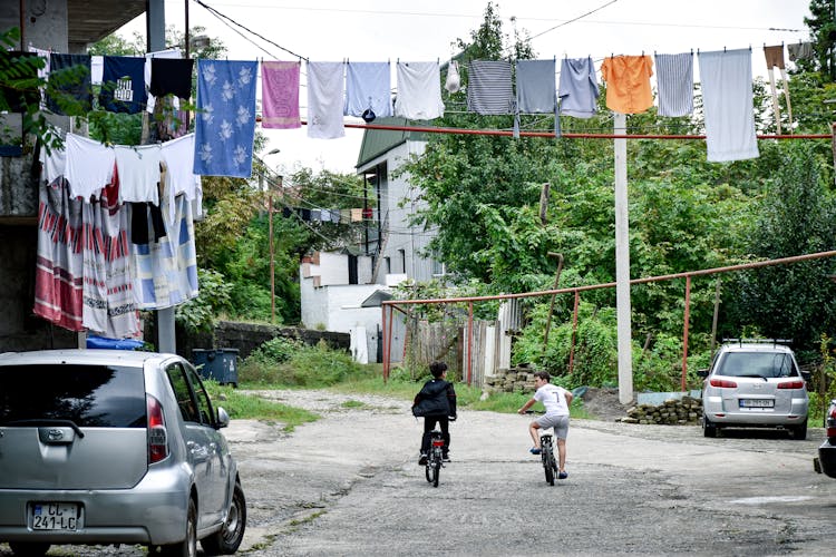 Kids Riding Their Bikes On The Street