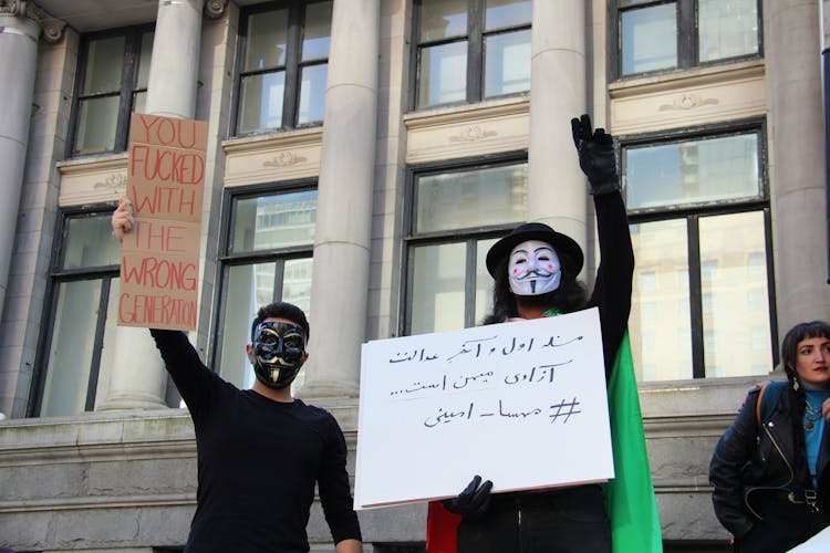 People Wearing Mask Holding Placards