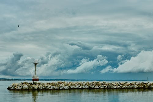Lighthouse on Rocks on Seashore