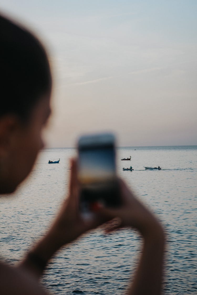 Person Taking Photo Of Sea On Cellphone