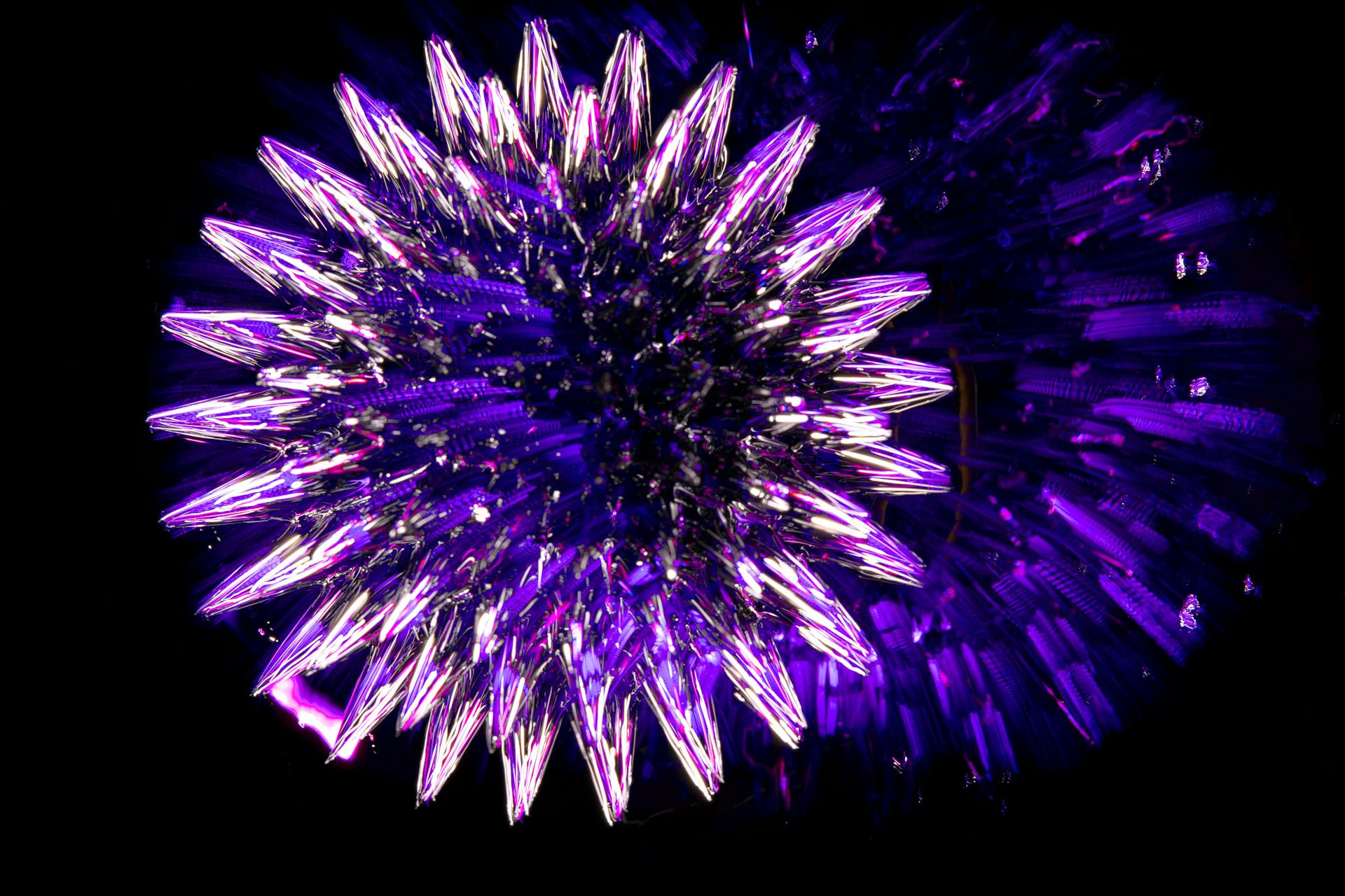 A vibrant and intricate glowing purple fractal resembling a crystal structure set against a dark background.