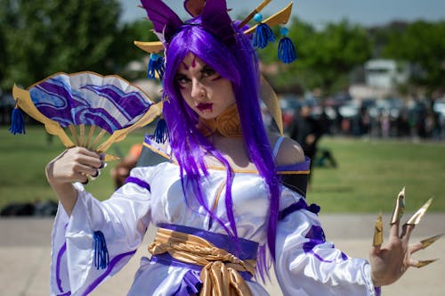 Woman Wearing Costume Holding a Fan