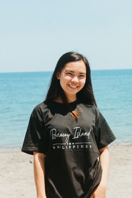 Free A cheerful Asian woman posing on the sunny beach of Boracay Island, Philippines. Stock Photo