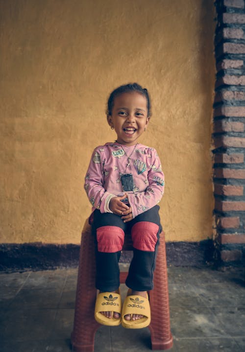 Little Girl Sitting on a Stool