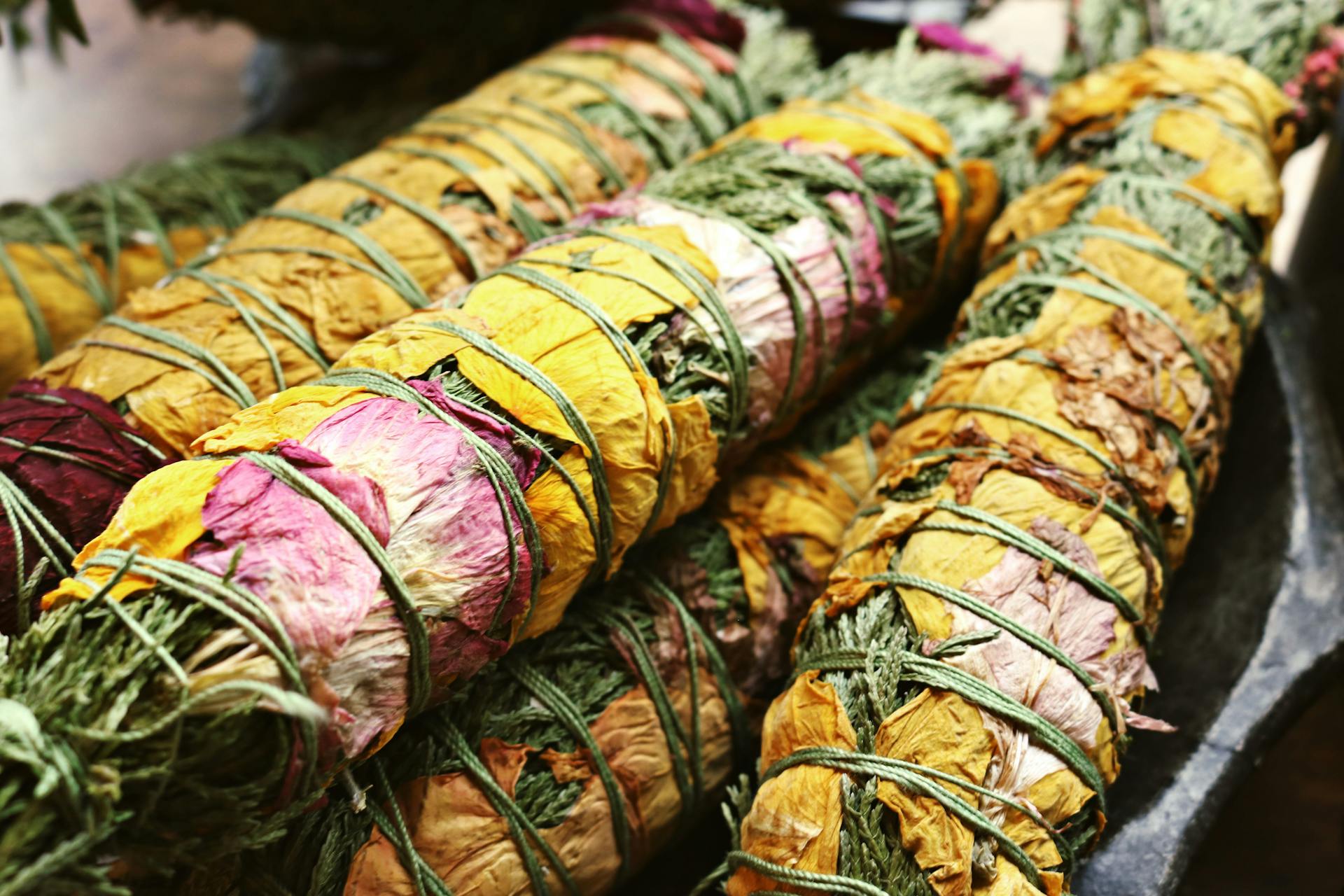 Close-up of colorful dried flower bundles tied for traditional artisanal decorations.