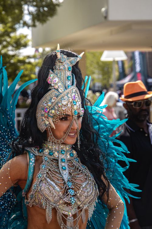 Free Colorful female performer in ornate costume at a festival parade, showcasing energy and culture. Stock Photo
