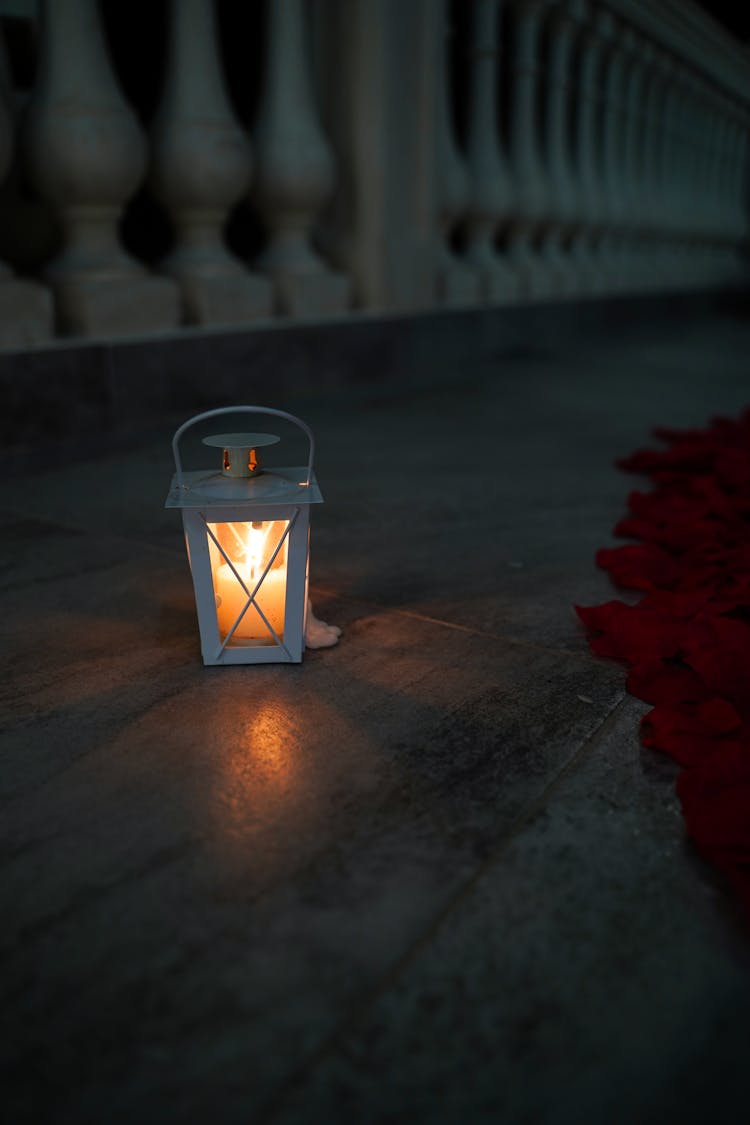 Lighted Candle Inside A Lamp