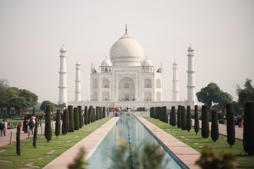 Free View of the iconic Taj Mahal with its reflecting pool and gardens in Agra, India. Stock Photo