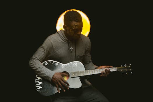 A musician with face paint plays guitar under a dramatic spotlight, conveying artistic expression.