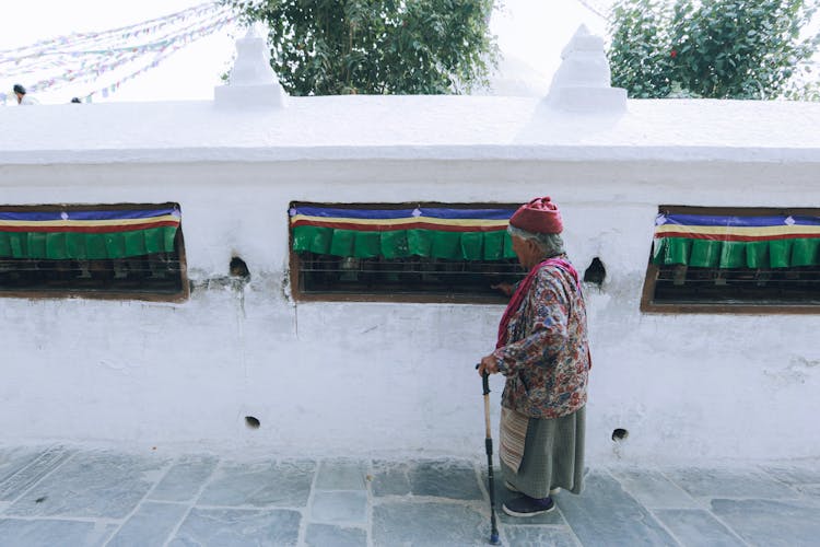 Eldery Woman With A Walking Stick 