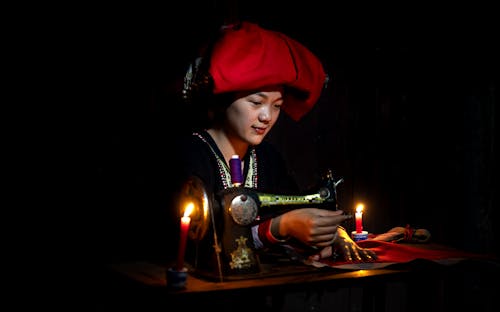 A Woman Sewing Using a Sewing machine