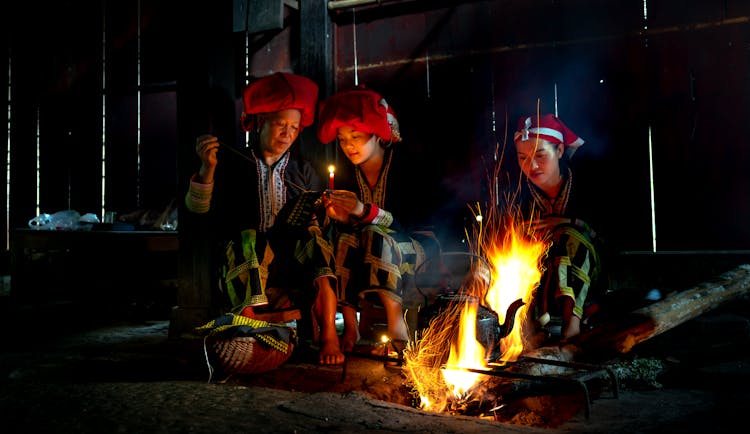 Red Dao Hill Tribe Women Sitting Around Burning Fire