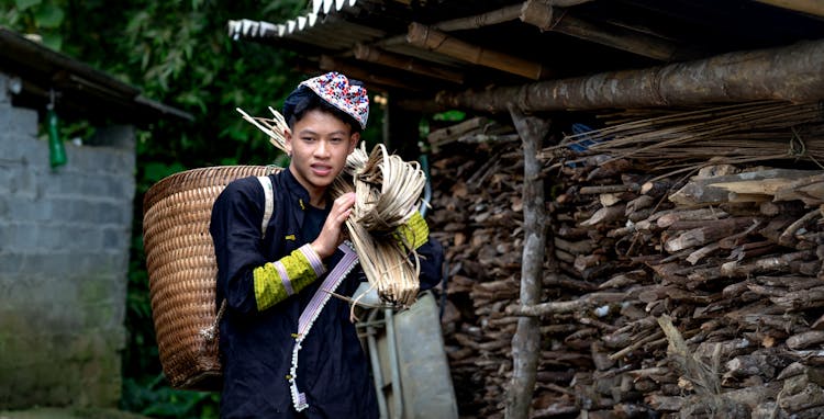 Teenager Boy Carrying Wood For Fuel