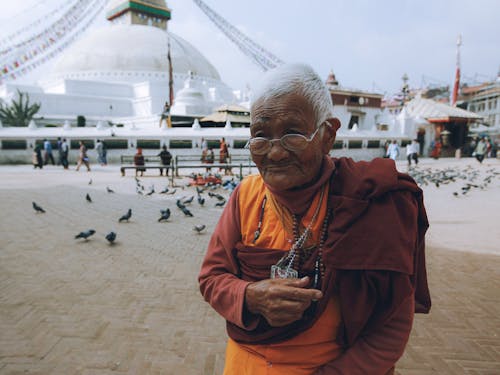 Photograph of an Elderly Woman Near Birds