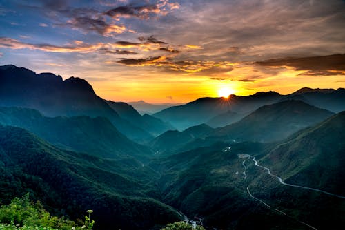 Aerial Photography of Green Mountains during Sunset 