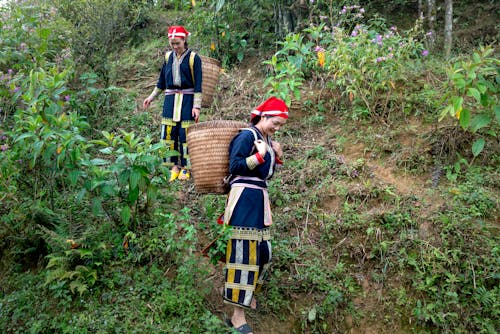 Women Carrying Baskets Walking Down the Hill