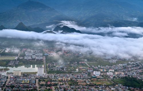 Free A stunning birds-eye view capturing the serene cityscape of Lai Chau with mountains and clouds. Stock Photo