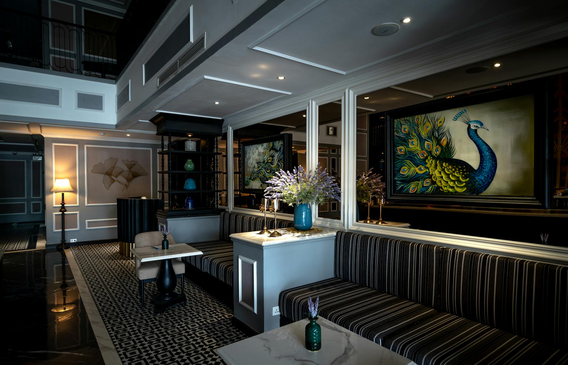 Luxurious hotel lobby featuring opulent decor, art, and comfortable seating for guests.