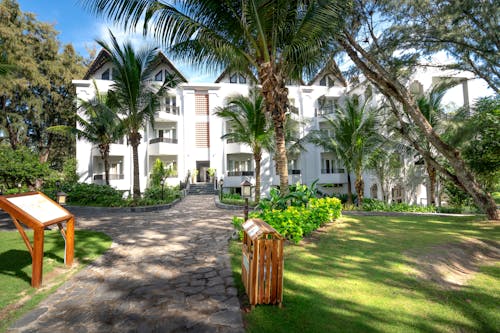 White Residential Building among Palm Trees